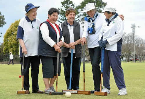 Croquet club members Margaret Thomas, Lesley Grayson, Dorothy Gartery, Joan Featherstone and president Peg Porter ignore threatening clouds. 